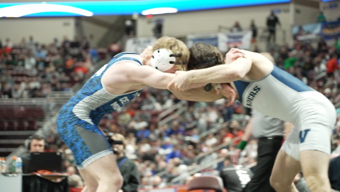 Two wrestlers facing off