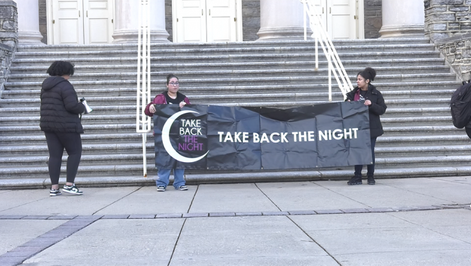 Women holding a banner that reads "Take Back the Night"