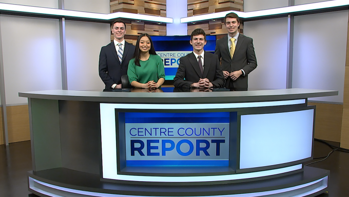 Four Centre County Report Anchors standing behind the Centre County Report anchor desk.