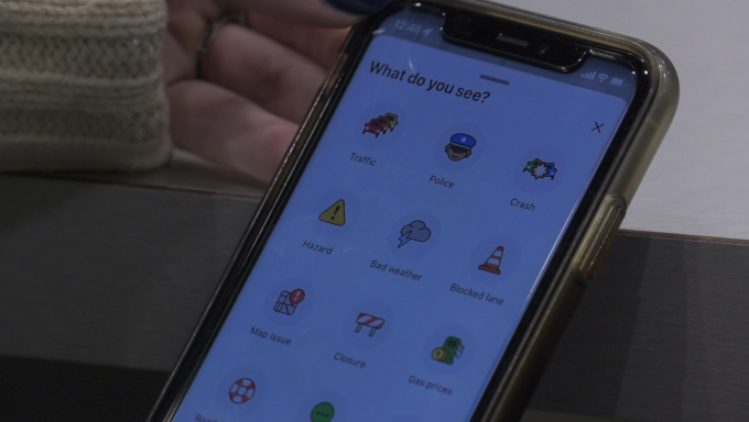 picture of phone using waze and the different options that can be reported on the app for other users