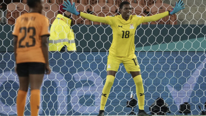 Goalie Eunice Sakala with outstretched arms in goal