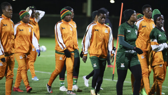 Members of the Zambian World Cup team walk onto the pitch