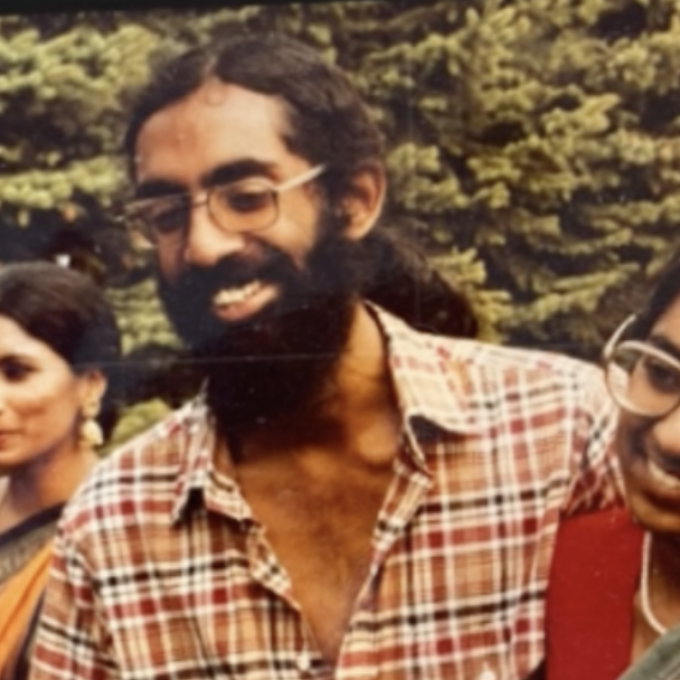 Three people hugging and smiling