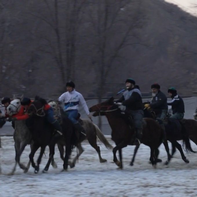 Kazakh horseback riders playing a game