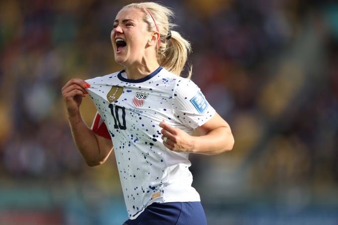 Soccer player tugs on white shirt to celebrate