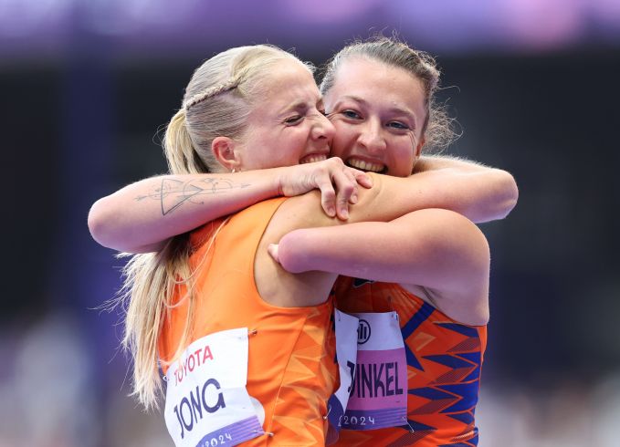 Two blond women hug