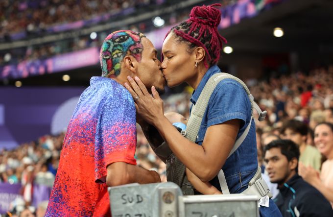 A man and woman share a kiss