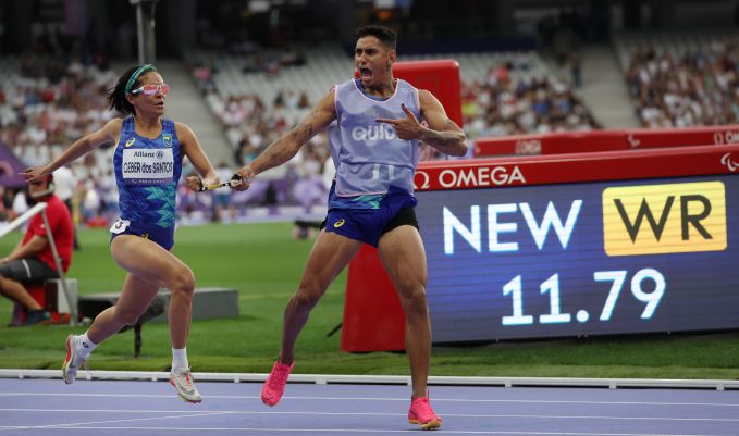 Runners in blue on a track