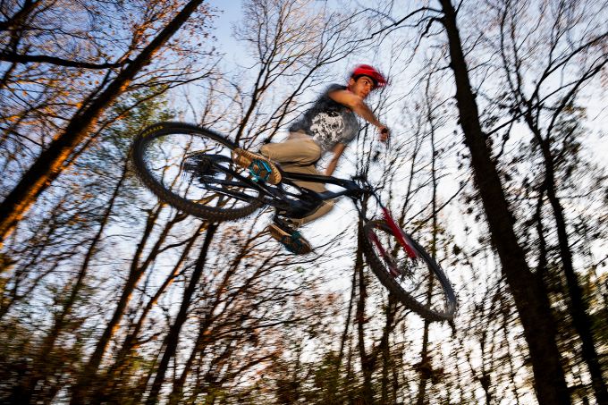 Trail bike gets air in the woods