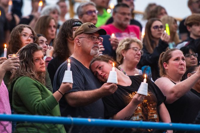 People holding white candles