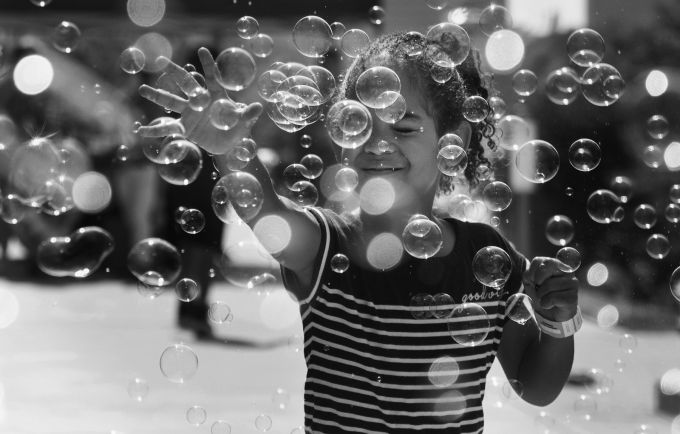 Child popping bubbles