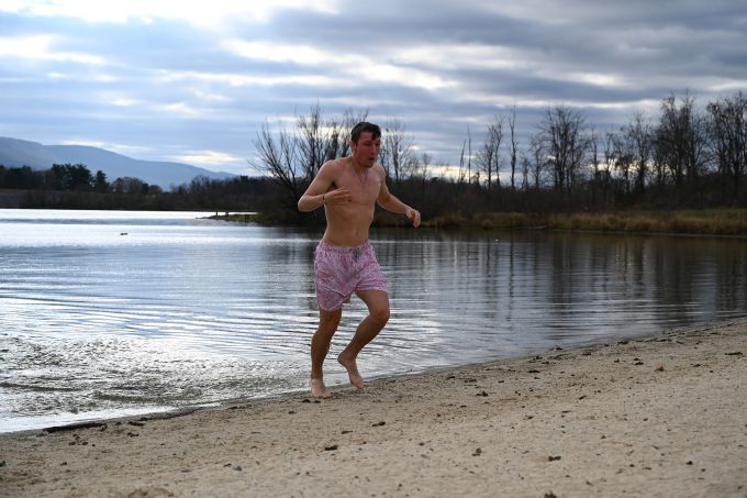 Man rushes out of a lake