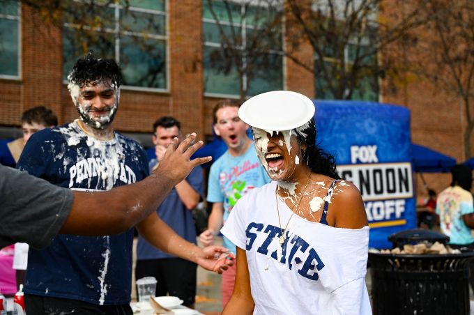 Woman in white shirt with pie on her face