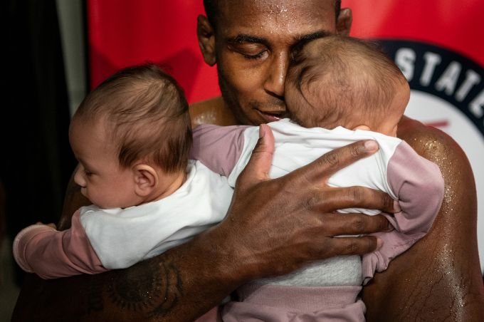 Man hugs two children