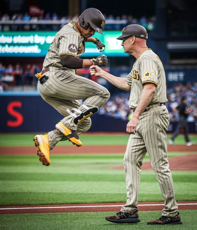 Baseball player hops as he arrives at first base