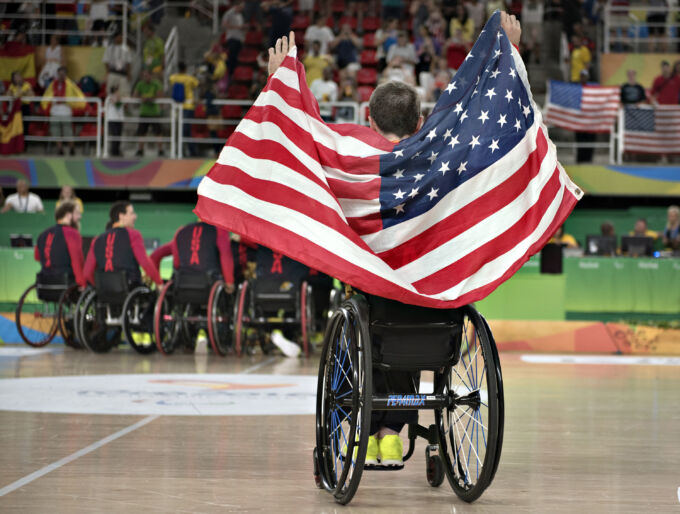 Wheelchair athlete holds flag