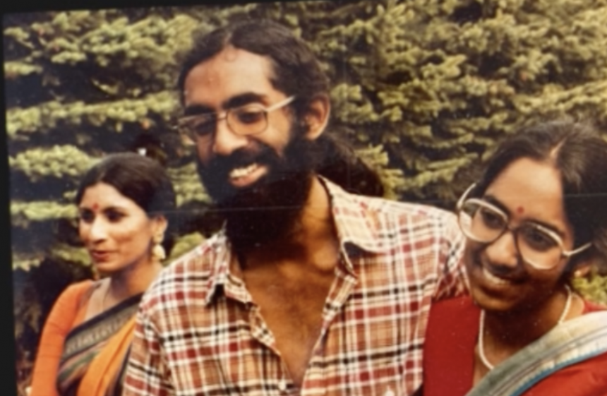 Three people hugging and smiling